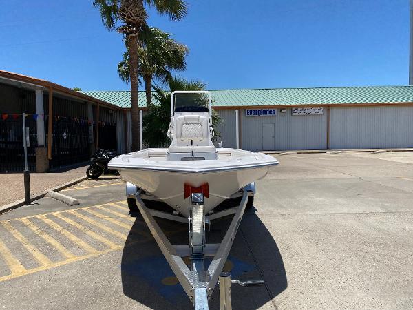 Slide: The Image of 2023 Blue Wave 2200 STL boat on a trailer in a parking lot. - 2