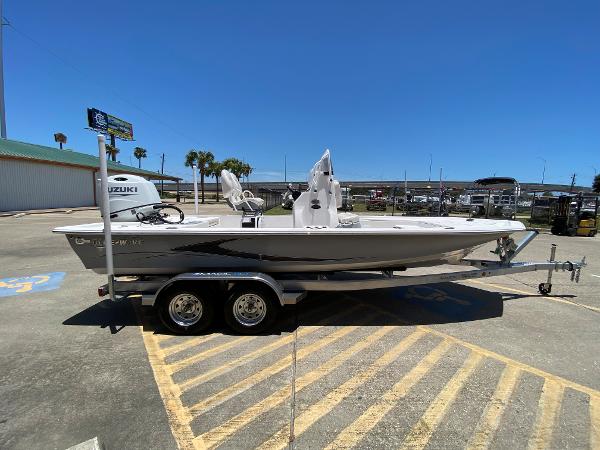 Slide: The Image of 2023 Blue Wave 2200 STL boat on a trailer in a parking lot. - 4