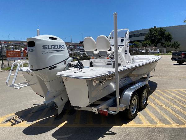 Slide: The Image of 2023 Blue Wave 2200 STL boat with Suzuki engine on trailer. - 5
