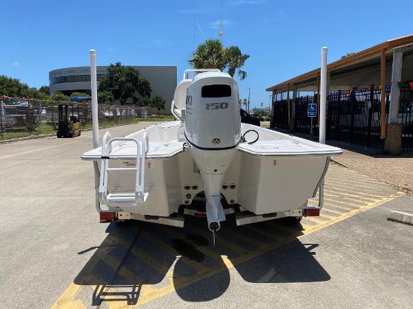 Slide: The Image of 2023 Blue Wave 2200 STL boat with 150 HP engine, rear view in parking lot. - 6