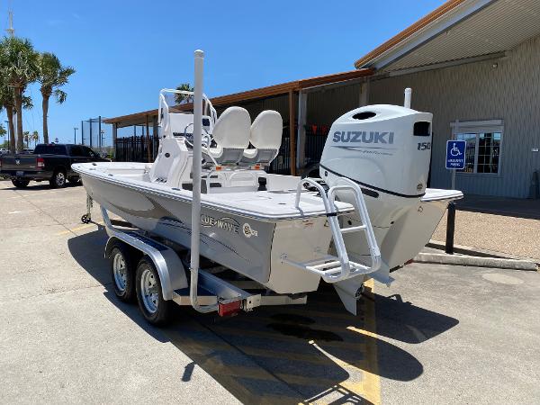 Slide: The Image of 2023 Blue Wave 2200 STL boat with Suzuki 150 engine on a trailer. - 7