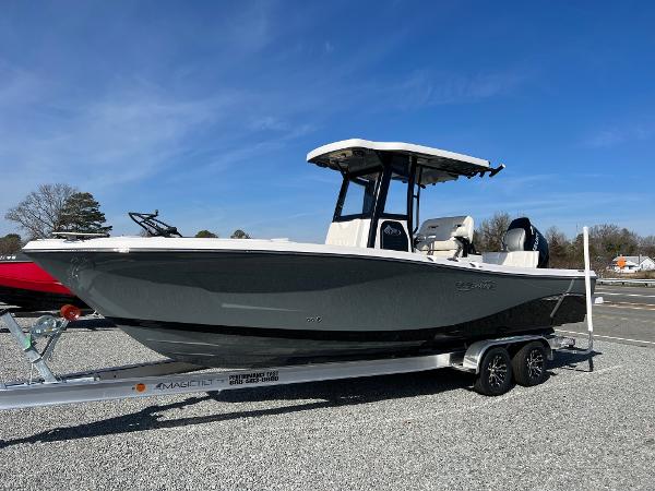 Slide: The Image of 2023 Blue Wave 2600 Makaira boat on a trailer under a clear blue sky. - 0