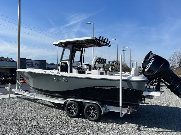 Slide: The Image of 2023 Blue Wave 2600 Makaira boat on a trailer with Suzuki outboard motor. - 1