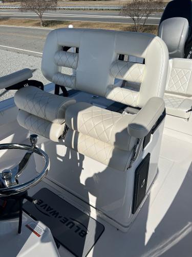 Slide: The Image of 2023 Blue Wave 2600 Makaira boat with luxurious white seating and steering wheel. - 7