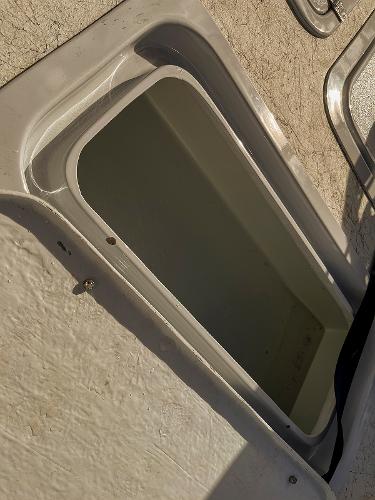 Slide: The Image of Open storage compartment on a 2022 Bossman 17 Flats Boat. - 6