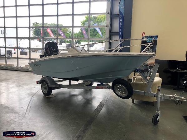 Slide: The Image of 2023 Boston Whaler 130 Super Sport boat on trailer in showroom. - 0