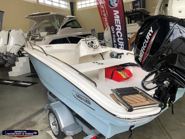 Slide: The Image of 2023 Boston Whaler 130 Super Sport boat with Mercury outboard motor on display. - 1
