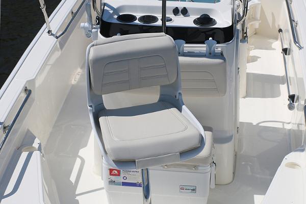 Slide: The Image of Manufacturer Provided Image: 2024 Boston Whaler 150 Montauk boat interior with cushioned seating and console. - 22