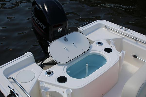 Slide: The Image of Manufacturer Provided Image: 2024 Boston Whaler 150 Montauk boat with open livewell and Mercury outboard motor. - 26