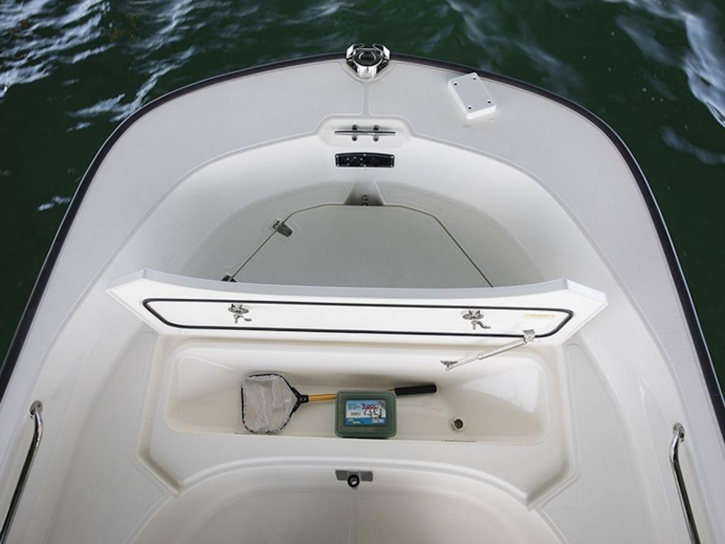 Slide: The Image of 2024 Boston Whaler 170 Montauk boat storage compartment with fishing gear. - 10