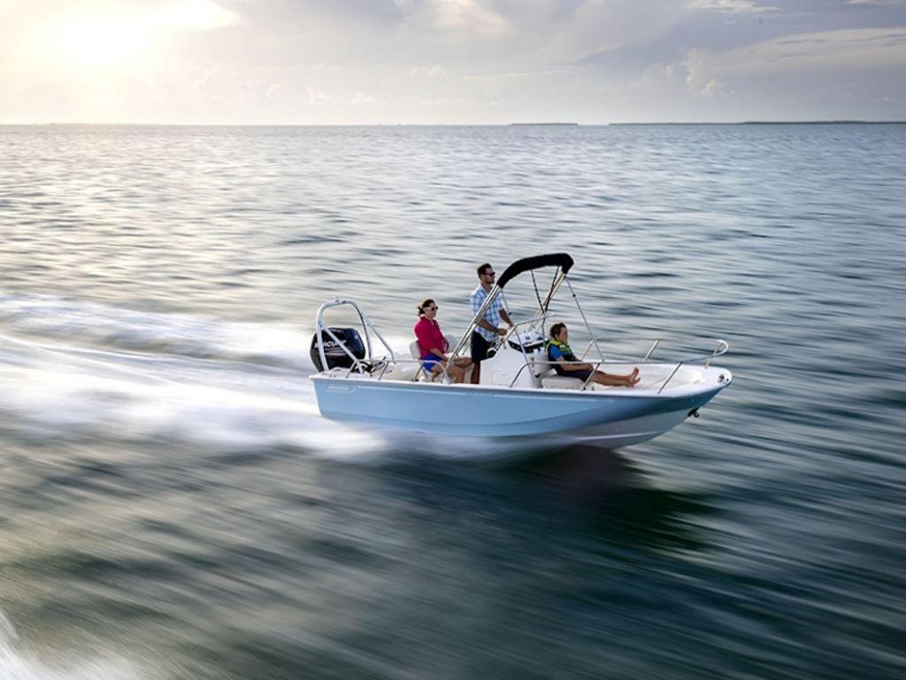 Slide: The Image of 2024 Boston Whaler 170 Montauk boat cruising on open water. - 2