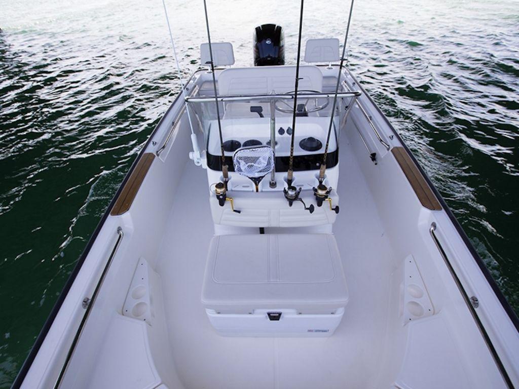 Slide: The Image of 2024 Boston Whaler 170 Montauk boat interior with fishing rods and seating. - 9