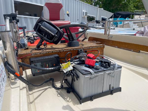 Slide: The Image of 1976 Boston Whaler 150 Sport boat interior with electronics and battery setup. - 10