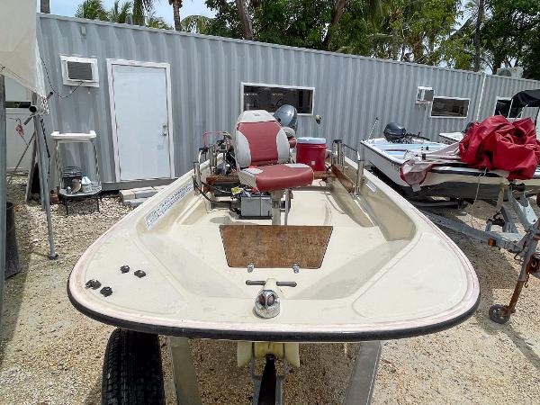 Slide: The Image of 1976 Boston Whaler 150 Sport boat in storage yard. - 2