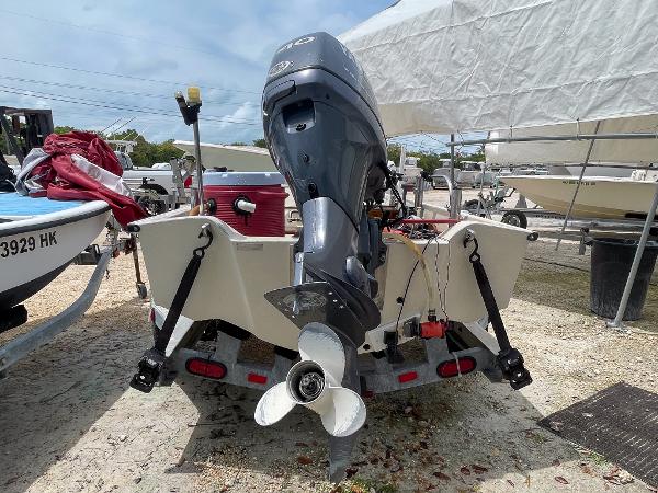 Slide: The Image of 1976 Boston Whaler 150 Sport boat on trailer, rear view with outboard motor. - 5