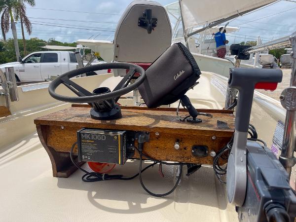 Slide: The Image of 1976 Boston Whaler 150 Sport boat dashboard with steering wheel and electronic equipment. - 8