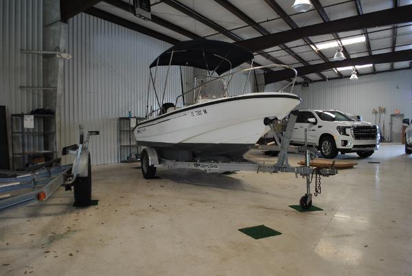 Slide: The Image of 2001 Boston Whaler 16 Dauntless boat on trailer in indoor storage facility. - 1
