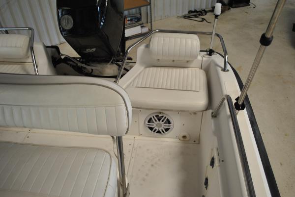 Slide: The Image of 2001 Boston Whaler 16 Dauntless boat interior with white cushioned seating and speaker. - 13
