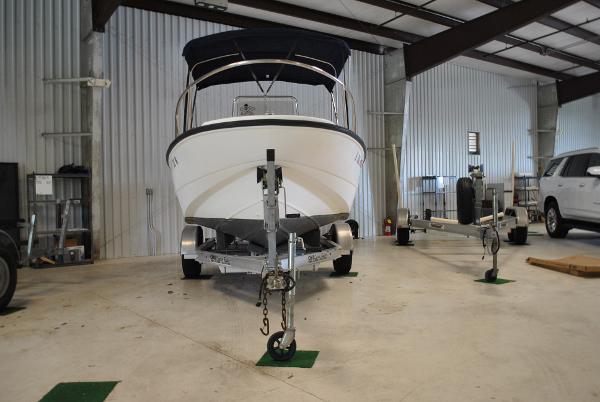 Slide: The Image of 2001 Boston Whaler 16 Dauntless boat on trailer in indoor storage facility. - 2