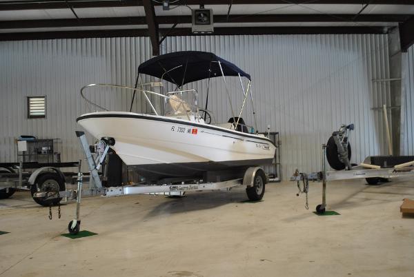 Slide: The Image of 2001 Boston Whaler 16 Dauntless boat on a trailer in a storage facility. - 3
