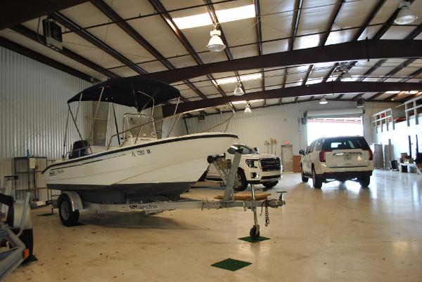 Slide: The Image of 2001 Boston Whaler 16 Dauntless boat in a spacious indoor storage facility. - 7