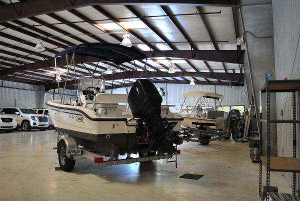 Slide: The Image of 2001 Boston Whaler 16 Dauntless boat in a storage facility. - 8