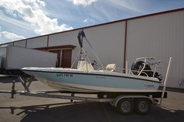 Slide: The Image of 2019 Boston Whaler 180 Dauntless boat on a trailer outside a warehouse. - 7
