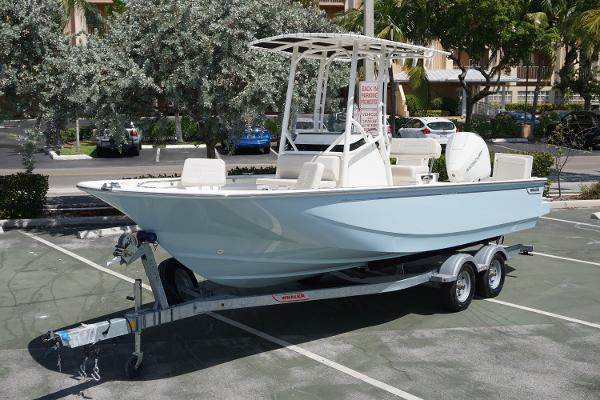 Slide: The Image of 2024 Boston Whaler 210 Montauk boat on a trailer in a parking lot. - 0