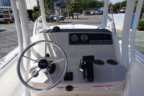 Slide: The Image of 2024 Boston Whaler 210 Montauk boat console with steering wheel and controls. - 13
