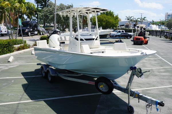 Slide: The Image of 2024 Boston Whaler 210 Montauk boat on a trailer in a parking lot. - 4