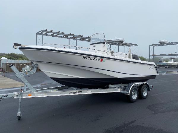 Slide: The Image of 2004 Boston Whaler 210 Outrage boat on a trailer in a marina. - 1