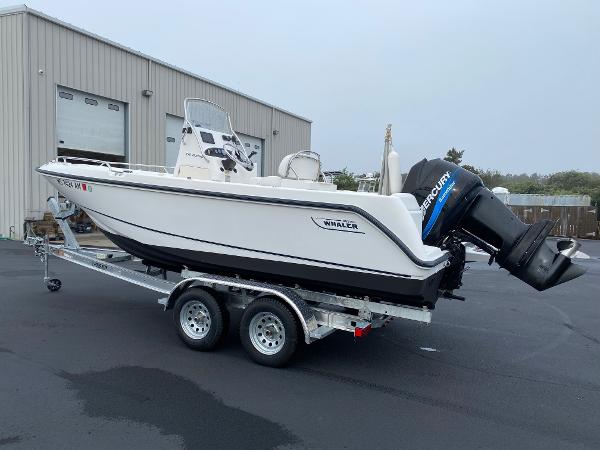Slide: The Image of 2004 Boston Whaler 210 Outrage boat on trailer with Mercury outboard motor. - 2