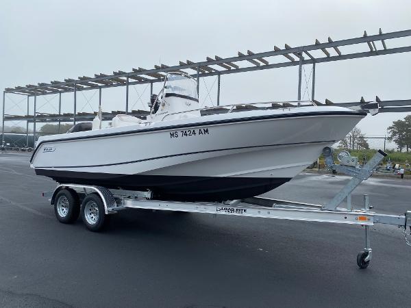 Slide: The Image of 2004 Boston Whaler 210 Outrage boat on a trailer in a parking lot. - 3