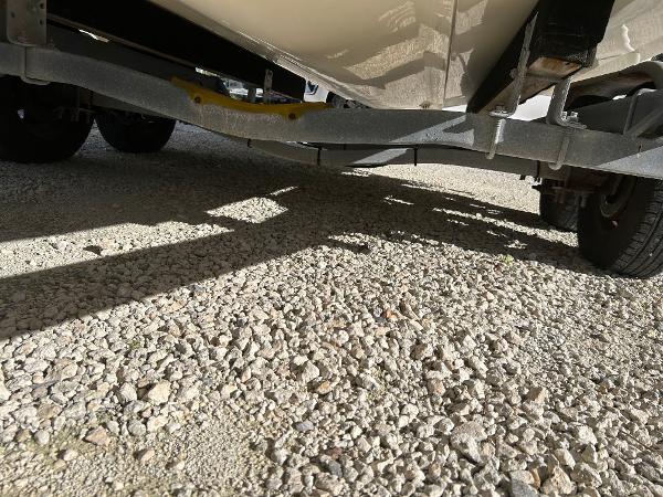 Slide: The Image of 2007 Boston Whaler 220 Dauntless trailer undercarriage on gravel surface. - 11
