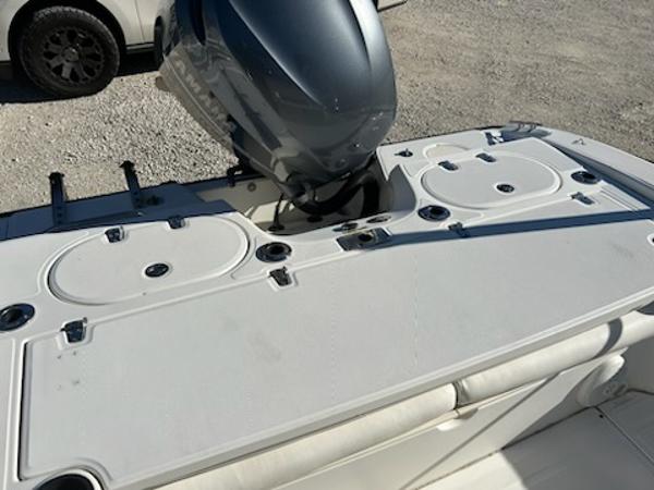 Slide: The Image of 2007 Boston Whaler 220 Dauntless boat with outboard motor and storage compartments. - 17
