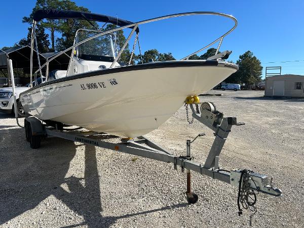 Slide: The Image of 2007 Boston Whaler 220 Dauntless boat on trailer in sunny outdoor setting. - 2