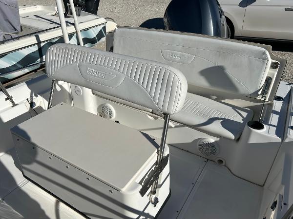 Slide: The Image of 2007 Boston Whaler 220 Dauntless boat seating area with white cushioned seats. - 24