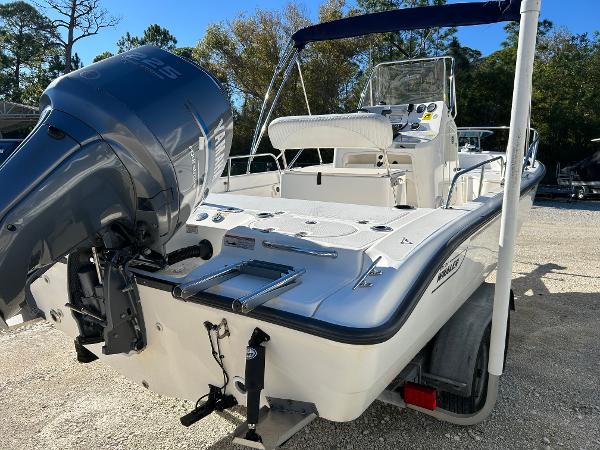 Slide: The Image of 2007 Boston Whaler 220 Dauntless boat with outboard motor, parked on trailer. - 7