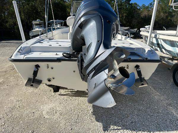Slide: The Image of 2007 Boston Whaler 220 Dauntless boat with outboard motor, parked on gravel. - 8