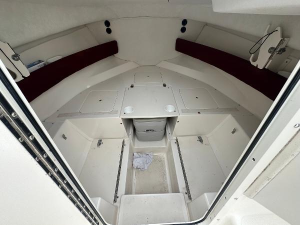 Slide: The Image of 1998 Boston Whaler 23 Conquest cabin interior with storage compartments and seating. - 12