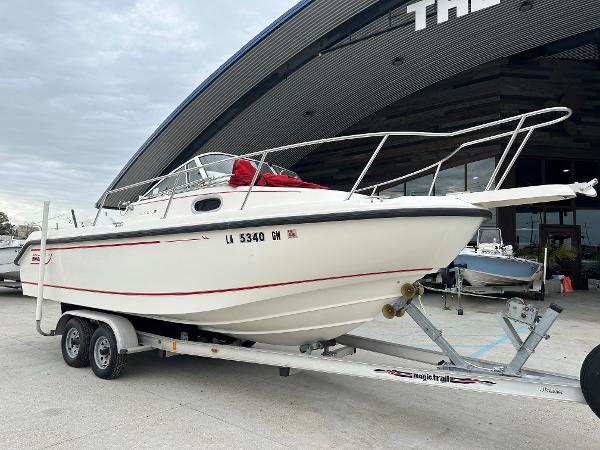 Slide: The Image of 1998 Boston Whaler 23 Conquest boat on trailer outside a building. - 22
