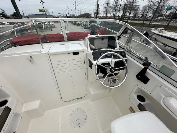 Slide: The Image of 1998 Boston Whaler 23 Conquest boat helm with steering wheel and navigation equipment. - 26