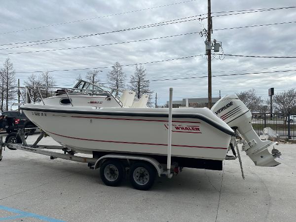 Slide: The Image of 1998 Boston Whaler 23 Conquest boat on a trailer with Evinrude outboard motor. - 4