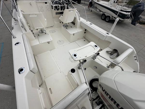 Slide: The Image of 1998 Boston Whaler 23 Conquest boat interior with seating and Evinrude outboard motor. - 7
