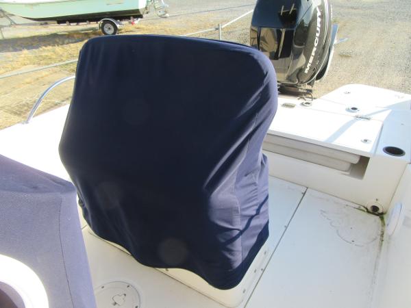 Slide: The Image of 2019 Boston Whaler 240 Dauntless boat with covered seating and Mercury outboard motor. - 8