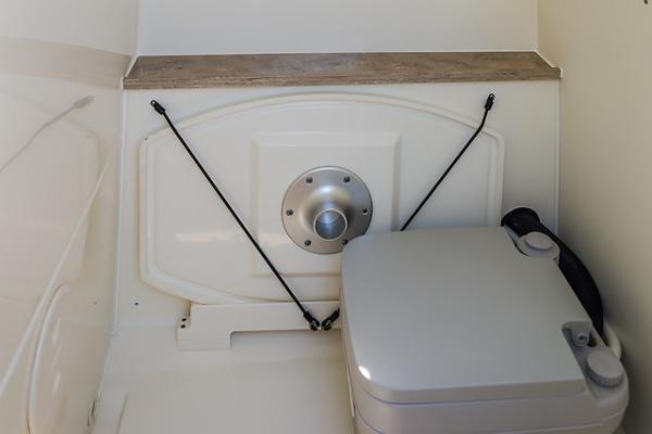 Slide: The Image of Interior of a 2021 Boston Whaler 270 Dauntless boat, featuring a compact marine toilet. - 31