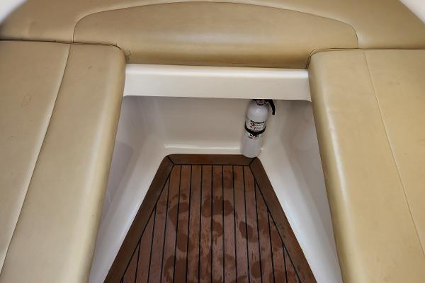Slide: The Image of 2008 Boston Whaler 320 Outrage Cuddy Cabin interior with cushioned seating and wooden flooring. - 23