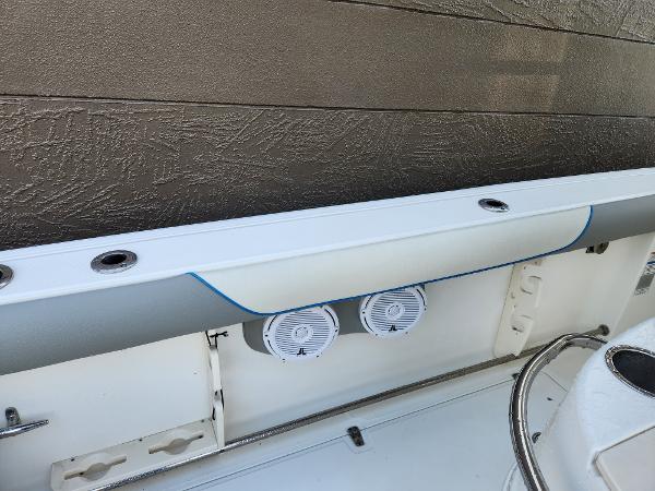 Slide: The Image of 2008 Boston Whaler 320 Outrage Cuddy Cabin interior detail with speakers and rod holders. - 28