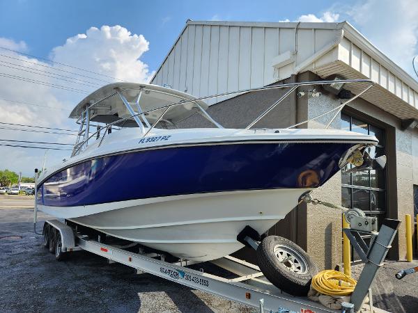 Slide: The Image of 2008 Boston Whaler 320 Outrage Cuddy Cabin on trailer, parked outside building. - 38