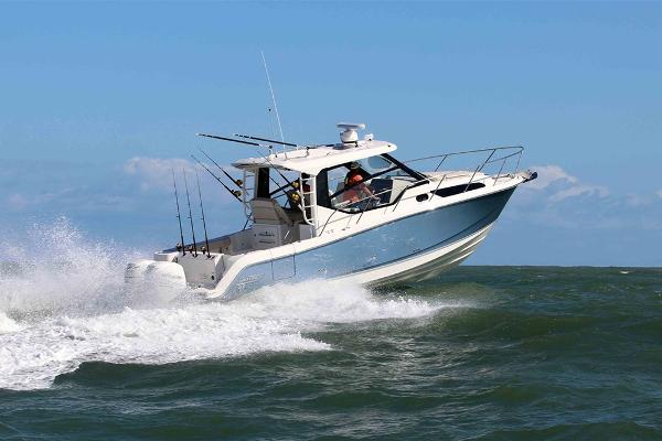 Slide: The Image of 2023 Boston Whaler 325 Conquest cruising on open water. - 1